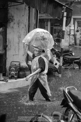 Woman wading through the flooded streets of Hanoi